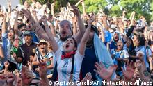 Argentina's soccer fans react as they watch their team's soccer match against Mexico at the World Cup, hosted by Qatar, in Buenos Aires, Argentina, Saturday, Nov. 26, 2022. (AP Photo/Gustavo Garello)