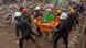 Rescuers carry a body bag containing the newly-recovered body of an earthquake victim in Cianjur, West Java, Indonesia, Rescuers carry a body bag containing the newly-recovered body of an earthquake victim in Cianjur, West Java, Indonesia,