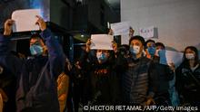 TOPSHOT - People show blank papers as a way to protest, is seen on a wall while gathering on a street in Shanghai on November 27, 2022, where protests against China's zero-Covid policy took place the night before following a deadly fire in Urumqi, the capital of the Xinjiang region. (Photo by Hector RETAMAL / AFP) (Photo by HECTOR RETAMAL/AFP via Getty Images)
