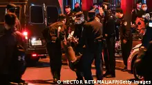 A man is arrested while people gathering on a street in Shanghai on November 27, 2022, where protests against China's zero-Covid policy took place the night before following a deadly fire in Urumqi, the capital of the Xinjiang region. (Photo by Hector RETAMAL / AFP) (Photo by HECTOR RETAMAL/AFP via Getty Images)