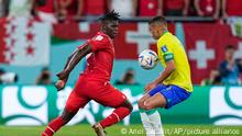 Switzerland's Breel Embolo, left, tussles for the ball with Brazil's Thiago Silva during the World Cup group G soccer match between Brazil and Switzerland, at the Stadium 974 in Doha, Qatar, Monday, Nov. 28, 2022. (AP Photo/Ariel Schalit)