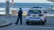 Police officer next to police car at Cronulla Beach, Sydney, New South Wales Police officer next to police car at Cronulla Beach, Sydney, New South Wales