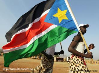 Ein Mann mit einer Fahne des Südsudan (Foto: dpa)