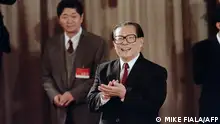 (FILES) In this file photo taken on October 19, 1992, General Secretary of the Chinese Communist Party Jiang Zemin applauds in Beijing during a press unveiling to introduce new members to the standing committee of the poliburo. - China's former leader Jiang Zemin, who steered the country through a transformational era from the late 1980s and into the new millennium, died November 30, 2022 at the age of 96, Xinhua reported. (Photo by Mike FIALA / AFP)