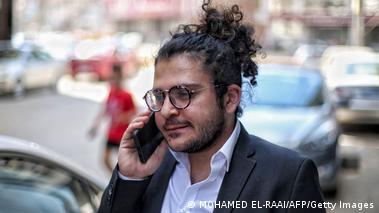 Egyptian Coptic Christian human rights activist Patrick Zaki on the street with his mobile phone