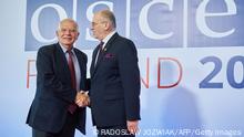 EU High Representative for Foreign Affairs and Security Policy Josep Borrell (L) and OSCE Chairperson-in-Office and Polish Foreign Minister Zbigniew Rau shake hands during the 29th Ministerial Council meeting of the OSCE (Organization for Security and Co-operation in Europe) in Lodz, Poland on December 1, 2022. (Photo by RADOSLAW JOZWIAK / AFP) (Photo by RADOSLAW JOZWIAK/AFP via Getty Images)
