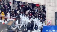 Shanghai residents confront coronavirus disease (COVID-19) staff dressed in protective clothing in Shanghai, China, in this still image obtained from a social media video released November 30, 2022. Video obtained by Reuters/via REUTERS THIS IMAGE HAS BEEN SUPPLIED BY A THIRD PARTY. NO RESALES. NO ARCHIVES