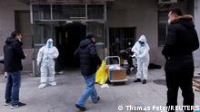 Pandemic prevention workers in protective suits get ready to enter an apartment building that went into lockdown as coronavirus disease (COVID-19) outbreaks continue in Beijing, December 2, 2022. REUTERS/Thomas Peter