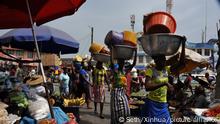 (220324) -- ACCRA, March 24, 2022 (Xinhua) -- Vendors sell products in a busy street in Accra, Ghana, on March 21, 2022. The Road Transport Coordinating Council in Ghana announced a 15 percent increase in transport fares in February as the ex-pump price of petroleum products increased constantly since the beginning of this year. TO GO WITH Feature: Ghanaians lament hardships amid fuel price, transport fare hikes (Photo by Seth/Xinhua)