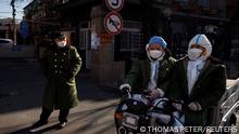 Pandemic prevention workers in protective suits ride an electric vehicle as coronavirus disease (COVID-19) outbreaks continue in Beijing, December 4, 2022. REUTERS/Thomas Peter