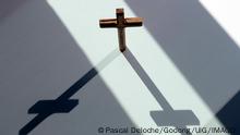 A wooden Easter cross symbol of the Crucifixion of Christ with a shadow. Faith and religion concept. Godongxxxxxcontactgodong-photo.com 971_07_es381383a
