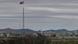 A North Korean village, with a flag atop a tower in the DMZ A North Korean village, with a flag atop a tower in the DMZ