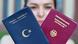 Woman holding German and Turkish passports into the camera Woman holding German and Turkish passports into the camera