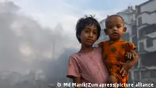 August 3, 2022, Dhaka, Bangladesh: children pose for a photo in an air polluted atmosphere in Dhaka. Most steel re-rolling mills in and around the capital have been running without the necessary air pollution control system posing a risk of air pollution and health hazard, according to findings of the Department of Environment (Credit Image: © Md Manik/SOPA Images via ZUMA Press Wire