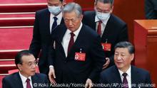 Hu Jintao (C) abruptly is left his seat by staffs during the closing ceremony of the National Congress of the Chinese Communist Party (NCCCP) at Great Hall of the People in Beijing, China on October 22, 2022.( The Yomiuri Shimbun via AP Images )