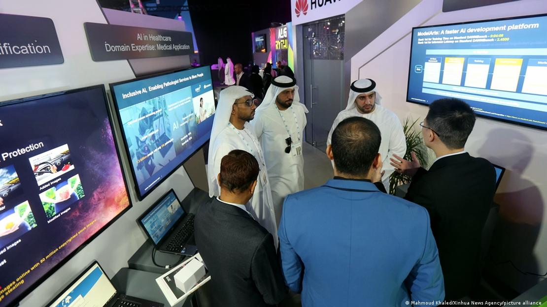Visitors are seen at the booth of Huawei at the first AI Everything Summit in Dubai.