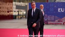Serbian President Aleksandar Vucic, left, during arrivals for the EU-Western Balkans Summit, in Tirana, Albania, Tuesday, Dec. 6, 2022. EU leaders and their Western Balkans counterparts gather Tuesday for talks aimed at boosting their partnership as Russia's war in Ukraine threatens to reshape the geopolitical balance in the region. (AP Photo/Andreea Alexandru)
