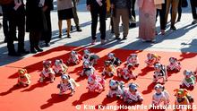 FILE PHOTO: People watch Sony's robotic dogs 'Aibo' during a ritual ceremony Sichi-Go-San, which is usually held for praying for children's health and wellbeing, at the Kanda Myojin shrine in Tokyo, Japan, November 11, 2022. REUTERS/Kim Kyung-Hoon/File Photo