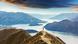 A person stands at Roys Peak in New Zealand A person stands at Roys Peak in New Zealand