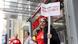 A guild member holds a placard supporting a union walk out, outside the New York Times building in Manhattan A guild member holds a placard supporting a union walk out, outside the New York Times building in Manhattan