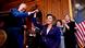 A presidente da Câmara dos Representantes, Nancy Pelosi, é cumprimentada por parlamentares após assinar o projeto de lei que garante proteção ao casamento gay e inter-racial nos Estados Unidos. Ela veste um terno azul escuro. Ao fundo, as pessoas aplaudem e há uma bandeira dos Estados Unidos. A presidente da Câmara dos Representantes, Nancy Pelosi, é cumprimentada por parlamentares após assinar o projeto de lei que garante proteção ao casamento gay e inter-racial nos Estados Unidos. Ela veste um terno azul escuro. Ao fundo, as pessoas aplaudem e há uma bandeira dos Estados Unidos.