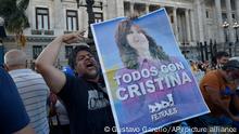 A supporter of Argentine Vice President Cristina Fernandez holds a poster with a message that reads in Spanish: All with Cristina, after Fernandez, a former president, was sentenced to 6 years in prison and banned from political office for life, outside Congress in Buenos Aires, Argentina, Tuesday, Dec. 6, 2022. Fernandez is accused of running a criminal organization that defrauded the state of $1 billion during her presidency through public works contracts granted to a construction magnate closely tied to her family. (AP Photo/Gustavo Garello) being sentenced to 6 years in prison and banned from political office for life, outside Congress in Buenos Aires, Argentina, Tuesday, Dec. 6, 2022. Fernandez is accused of running a criminal organization that defrauded the state of $1 billion during her presidency through public works contracts granted to a construction magnate closely tied to her family. (AP Photo/Gustavo Garello)