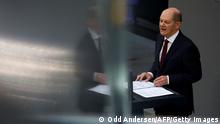 TOPSHOT - German Chancellor Olaf Scholz speak during an extraordinary session of the Bundestag (lower house of parliament) on February 27, 2022 in Berlin. - Germany on February 26, 2022 dramatically ramped up its backing for Ukraine's battle against Russia, approving weapons deliveries for Kyiv in a policy U-turn and agreeing to limit Moscow's access to the SWIFT interbank system. In a shift from its longstanding policy of banning weapons exports to conflict zones, Berlin is opening up its Bundeswehr store, pledging to transfer 1,000 anti-tank weapons and 500 Stinger class surface-to-air missiles to Ukraine. (Photo by Odd ANDERSEN / AFP) (Photo by ODD ANDERSEN/AFP via Getty Images)