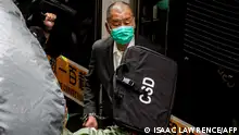 (FILES) This file photo taken on February 9, 2021 shows Hong Kong pro-democracy media tycoon Jimmy Lai arriving at the Court of Final Appeal to hear a decision on whether he will be granted bail, in Hong Kong. - Hong Kong pro-democracy media tycoon Jimmy Lai received a fresh jail sentence of five years and nine months on December 10, 2022 after being found guilty of fraud in a contractual dispute. (Photo by ISAAC LAWRENCE / AFP)