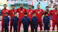 Iran players listen to the national anthem ahead of the Qatar 2022 World Cup Group B football match between England and Iran at the Khalifa International Stadium in Doha on November 21, 2022. (Photo by FADEL SENNA / AFP)
