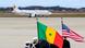 Senegal and US flags in the foreground with a plane in the background at an airbase Senegal and US flags in the foreground with a plane in the background at an airbase