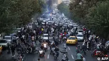 A picture obtained by AFP outside Iran on September 21, 2022, shows Iranian demonstrators taking to the streets of the capital Tehran during a protest for Mahsa Amini, days after she died in police custody. - Protests spread to 15 cities across Iran overnight over the death of the young woman Mahsa Amini after her arrest by the country's morality police, state media reported today.In the fifth night of street rallies, police used tear gas and made arrests to disperse crowds of up to 1,000 people, the official IRNA news agency said. (Photo by AFP)