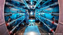 In this 2012 image provided by Lawrence Livermore National Laboratory, a technician reviews an optic inside the preamplifier support structure at the Lawrence Livermore National Laboratory in Livermore, Calif. Officials at the Department of Energy say on Tuesday, Dec. 13, 2022, there will be an announcement of a “major scientific breakthrough” on nuclear fusion. (Damien Jemison/Lawrence Livermore National Laboratory via AP)