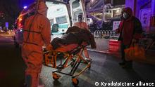 A patient is transported by ambulance to a fever outpatient section of a hospital in central Beijing on Dec. 9, 2022, as China braces for a possible surge in COVID-19 cases following the recent easing of restrictions. (Kyodo)