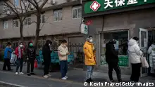 BEIJING, CHINA - DECEMBER 09: People wait in line to buy medicine at a pharmacy on December 9, 2022 in Beijing, China. As part of a 10 point directive, Chinas government announced Wednesday that people with COVID-19 who have mild or no symptoms will be permitted to quarantine at home instead of at a government facility, testings requirements are reduced, people are permitted to buy over the counter medications, and local officials can no longer lock down entire neighbourhoods or cities, a major shift in its zero COVID policy. (Photo by Kevin Frayer/Getty Images)