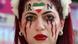 An Iran supporter with her face made up to show tears of blood under a heart in the Iranian colours An Iran supporter with her face made up to show tears of blood under a heart in the Iranian colours