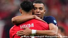 France's Kylian Mbappe hugs Morocco's Achraf Hakimi at the end of the World Cup semifinal soccer match between France and Morocco at the Al Bayt Stadium in Al Khor, Qatar, Wednesday, Dec. 14, 2022. France won 2-0 and will play Argentina in Sunday's final. (AP Photo/Manu Fernandez)