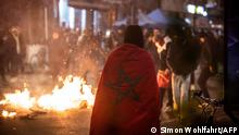 Moroccan supporters light up a fire in a street after Morocco's football team lost the Qatar 2022 World Cup semi-final football match against France, in Brussels on December 14, 2022. - The city center of Brussels faced tensions after the football game and clashes between police and some supporters. (Photo by Simon Wohlfahrt / AFP)