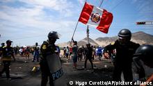 Supporters of ousted Peruvian President Pedro Castillo protest on the Pan-American North Highway while police officers arrive to clear debris, in Chao, Peru, Thursday, Dec. 15, 2022. Peru's new government declared a 30-day national emergency on Wednesday amid violent protests following Castillo's ouster, suspending the rights of personal security and freedom across the Andean nation. (AP Photo/Hugo Curotto)