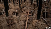 This photograph taken on September 25, 2022, shows empty graves after exhumation of bodies in the mass grave created during the Russian's occupation in Izyum, Kharkiv region, amid the Russian invasion of Ukraine. (Photo by Yasuyoshi CHIBA / AFP)