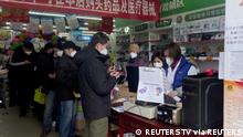 14.12.2022 *** FILE PHOTO: People stand in a queue to purchase medicines at a pharmacy in Beijing, China December 14, 2022, in this screen grab taken from a Reuters TV video. REUTERS TV via REUTERS/File Photo