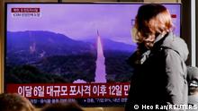 A woman walks past a TV broadcasting a news report on North Korea firing a ballistic missile off its east coast, in Seoul, South Korea, December 18, 2022. REUTERS/ Heo Ran