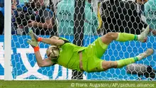 Argentina's goalkeeper Emiliano Martinez saves a penalty shot during the World Cup final soccer match between Argentina and France at the Lusail Stadium in Lusail, Qatar, Sunday, Dec. 18, 2022. (AP Photo/Frank Augstein)