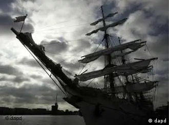 The German navy training vessel Gorch Fock at anchor, silhouetted against an overcast sky