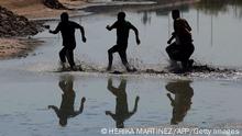TOPSHOT - Venezuelan migrants run as they cross the Rio Bravo, or Rio Grande as it is called in the US, into the United States to seek for political asylum, as seen from Ciudad Juarez, Chihuahua State, Mexico, on September 12, 2022. (Photo by Herika MARTINEZ / AFP) (Photo by HERIKA MARTINEZ/AFP via Getty Images)