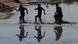 Siluetas de tres personas cruzando el Río Bravo. Siluetas de tres personas cruzando el Río Bravo.