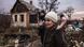 A woman holds her hands in the airs after having recently returned to her damaged house in the village of Bohorodychne, eastern Ukraine, on December 20, 2022 A woman holds her hands in the airs after having recently returned to her damaged house in the village of Bohorodychne, eastern Ukraine, on December 20, 2022