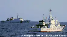 In this photo provided by the Philippine Coast Guard, a Chinese Coast Guard ship sails near a Philippine Coast Guard vessel during its patrol at Bajo de Masinloc, 124 nautical miles west of Zambales province, northwestern Philippines on March 2, 2022. The Philippines has sought an explanation from China after a Filipino military commander reported that the Chinese coast guard forcibly seized Chinese rocket debris in the possession of Filipino navy personnel in the disputed South China Sea, officials said Thursday, Nov. 24, 2022. (Philippine Coast Guard via AP)