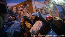 EL PASO, TEXAS - DECEMBER 17: Immigrants wait to enter a shelter at the Sacred Heart Church on December 17, 2022 in El Paso, Texas. Migrants crossed over the border from Mexico in previous days, seeking political asylum. U.S. border authorities predict a surge of migrants with the end of Title 42 on December 21. John Moore/Getty Images/AFP (Photo by JOHN MOORE / GETTY IMAGES NORTH AMERICA / Getty Images via AFP)