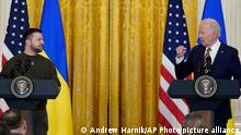 Ukrainian President Volodymyr Zelenskyy listens as President Joe Biden speaks during a news conference in the East Room of the White House in Washington, Wednesday, Dec. 21, 2022. (AP Photo/Andrew Harnik)