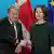 German Foreign Minister Annalena Baerbock shakes hands with Danish Foreign Minister Lars Lokke Rasmussen in Berlin in front of Danish and EU flags